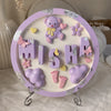 Custom Handcrafted Purple & Silver Resin Name Plaque with Teddy Bear & Baby Accents — Designed by Maira